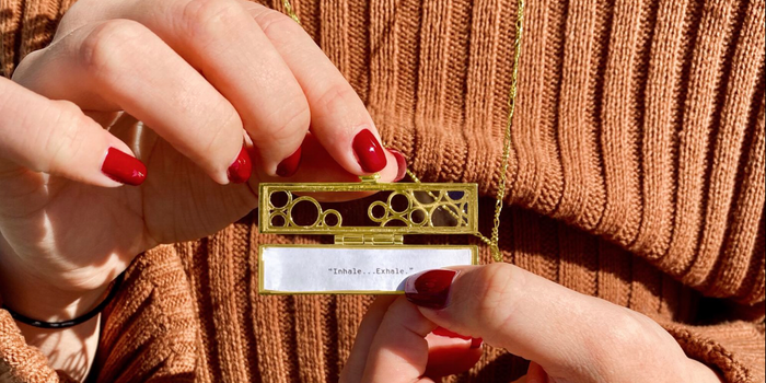 Shown here: Our Flowered Vines Fortune Locket with self-care reminder inside.